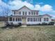 Charming two-story home with a welcoming front porch and a bright yellow front door at 1009 Bittbourg Ln, Wendell, NC 27591