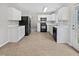 A bright, spacious kitchen featuring white cabinets and black appliances at 1009 Bittbourg Ln, Wendell, NC 27591