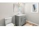 Modern bathroom featuring a gray vanity with a marble countertop and stylish fixtures at 105 Old Lowery Ct, Raleigh, NC 27614