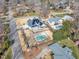 Expansive aerial view of a home with a pristine pool, solar panels, and a well-manicured lawn at 1100 Kingwood Dr, Raleigh, NC 27609