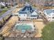 Aerial view of a home with solar panels, a spacious backyard, a pool, and lush landscaping at 1100 Kingwood Dr, Raleigh, NC 27609