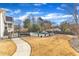 Manicured lawn and backyard with a refreshing pool and elegant stone walkway at 1100 Kingwood Dr, Raleigh, NC 27609
