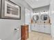 Bathroom featuring double sink vanity with granite countertop, framed mirrors, and neutral decor at 1100 Kingwood Dr, Raleigh, NC 27609