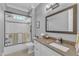 Well-lit bathroom featuring a single vanity, a toilet, and a shower with a glass door at 1100 Kingwood Dr, Raleigh, NC 27609