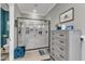 Modern bathroom featuring a spacious glass shower and a gray dresser for storage at 1100 Kingwood Dr, Raleigh, NC 27609