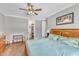Cozy bedroom with hardwood floors and light green walls at 1100 Kingwood Dr, Raleigh, NC 27609