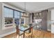 Inviting dining area with ample natural light, a modern light fixture, and a built-in wet bar area at 1100 Kingwood Dr, Raleigh, NC 27609