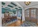 Elegant dining room with coffered ceilings, large windows, and hardwood flooring at 1100 Kingwood Dr, Raleigh, NC 27609