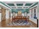 Elegant dining room features coffered ceilings, modern lighting, and ample seating for dinner parties at 1100 Kingwood Dr, Raleigh, NC 27609