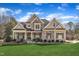 Charming two-story home with a manicured lawn, stone accents, and inviting front porch at 1100 Kingwood Dr, Raleigh, NC 27609