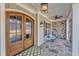 Close up of the front porch featuring a craftsman-style door and stone flooring at 1100 Kingwood Dr, Raleigh, NC 27609
