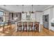 Bright kitchen with a large central island with seating and stainless steel appliances at 1100 Kingwood Dr, Raleigh, NC 27609