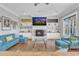 Cozy living room featuring a fireplace, built-in shelving, and comfortable seating at 1100 Kingwood Dr, Raleigh, NC 27609