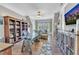 Home office with hardwood floors, custom shelving, and a glass desk at 1100 Kingwood Dr, Raleigh, NC 27609