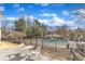 Backyard area with a pool, a dining table, and a small table with chairs surrounded by stone landscaping at 1100 Kingwood Dr, Raleigh, NC 27609