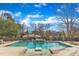 Backyard featuring a beautiful pool with a tranquil view of the surrounding trees and landscaping at 1100 Kingwood Dr, Raleigh, NC 27609