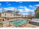 Backyard featuring a swimming pool, with an exterior view of the home and solar panels at 1100 Kingwood Dr, Raleigh, NC 27609