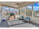 Relaxing sunroom with wicker furniture, a ceiling fan, and large windows offering beautiful views at 1100 Kingwood Dr, Raleigh, NC 27609