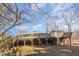 View of a large back deck on a split level house with a staircase leading down into the yard at 114 Evelyn Dr, Knightdale, NC 27545
