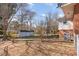 View of the backyard with a shed, a deck, and mature trees, with ample space for outdoor activities at 114 Evelyn Dr, Knightdale, NC 27545