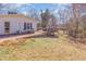 Spacious backyard with a deck, patio, and mature trees at 114 Evelyn Dr, Knightdale, NC 27545