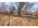 Scenic backyard features mature trees casting shadows on the open lawn at 114 Evelyn Dr, Knightdale, NC 27545