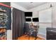 A bedroom and office space with multiple monitors and storage at 114 Evelyn Dr, Knightdale, NC 27545