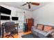 Bedroom with a gray sofa, wooden dresser, and a dedicated workstation at 114 Evelyn Dr, Knightdale, NC 27545