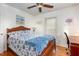 Cozy bedroom with hardwood floors, a wooden bed frame, and decor art pieces on the walls at 114 Evelyn Dr, Knightdale, NC 27545