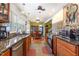Kitchen featuring stainless steel appliances, wooden cabinets, granite countertops, and dining area at 114 Evelyn Dr, Knightdale, NC 27545