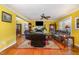 Spacious living room with hardwood floors, yellow walls, and a ceiling fan at 114 Evelyn Dr, Knightdale, NC 27545