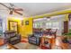 Living room with hardwood floors, yellow walls, and view to dining area at 114 Evelyn Dr, Knightdale, NC 27545