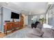 Cozy living room featuring a gray sofa, dark recliner, a decorative buffet, and a wall-mounted TV at 114 Evelyn Dr, Knightdale, NC 27545