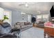 A bright living room with gray sofas, hardwood floors, and soft lighting at 114 Evelyn Dr, Knightdale, NC 27545