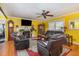 Cozy living room featuring hardwood floors, a ceiling fan, and natural light at 114 Evelyn Dr, Knightdale, NC 27545