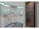 Bathroom with dual sinks, framed mirrors and a glass-enclosed tiled shower at 119 Patterson Dr, Youngsville, NC 27596