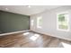 Spacious basement with wood-look flooring, neutral paint, and a walk-out door to the backyard at 120 Weavers Grove Dr, Chapel Hill, NC 27514