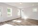 Finished basement featuring neutral walls, wood-look flooring, and multiple windows for natural light at 120 Weavers Grove Dr, Chapel Hill, NC 27514