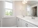 Bathroom with a double sink vanity, a large mirror, and a window with natural light at 120 Weavers Grove Dr, Chapel Hill, NC 27514