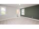 Bedroom with neutral carpet, a dark accent wall, and an en-suite bathroom visible through the doorway at 120 Weavers Grove Dr, Chapel Hill, NC 27514