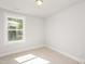 Bright bedroom features neutral carpet, gray walls, and window that provides natural light at 120 Weavers Grove Dr, Chapel Hill, NC 27514