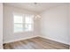 Bright dining room featuring modern chandelier, vinyl flooring, and large window at 120 Weavers Grove Dr, Chapel Hill, NC 27514