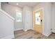 Bright foyer with a striking yellow front door, wood-look flooring, and ample natural light at 120 Weavers Grove Dr, Chapel Hill, NC 27514