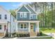 Charming two-story home featuring blue siding, a welcoming front porch, and manicured landscaping at 120 Weavers Grove Dr, Chapel Hill, NC 27514