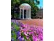 Scenic view of The Old Well with blooming flowers and lush greenery at 120 Weavers Grove Dr, Chapel Hill, NC 27514