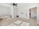 Bonus room with large windows, neutral furniture, ceiling fan, and basketball hoop at 140 Big Barn Dr, Wendell, NC 27591