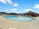 Community pool with water fountains, lounge chairs, umbrellas and pool house with seating area at 140 Big Barn Dr, Wendell, NC 27591