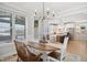 Bright dining area with wood table, chandelier, and large windows overlooking the view at 140 Big Barn Dr, Wendell, NC 27591