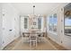 Charming dining room with natural light, hardwood floors, and a farmhouse-style table at 140 Big Barn Dr, Wendell, NC 27591