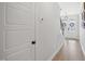 Bright hallway featuring hardwood floors, white trim, and views of the front entry at 140 Big Barn Dr, Wendell, NC 27591